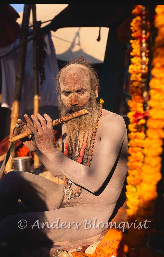  Naked sadhu playing his flute 
